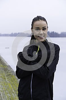 Beautiful Swedish caucasian fitness teen girl standing on wood bridge outdoor in winter landscape