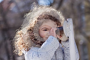 Beautiful sweet curly blond girl outdoor playing in the park 4 years old