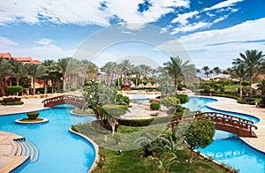 Beautiful swimming pool with wooden bridges in sunny weather.