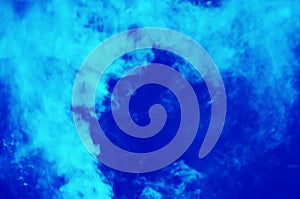 Beautiful swirl and fluffy soft white smoke on blue cackground