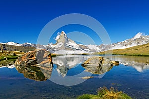 Beautiful Swiss Alps landscape with lake and mountains reflection in water