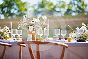 Beautiful table set with candles and flowers for a festive event, party or wedding reception