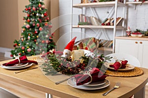 Beautiful table setting with Christmas decor in living room