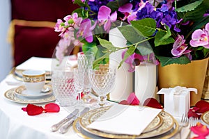 Beautiful table setting with crockery and flowers for a party, wedding reception or other festive event