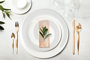 Beautiful table setting with cutlery, napkin and dinnerware