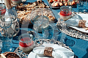 Beautiful table setting with plate, white napkin, wine and water glass.