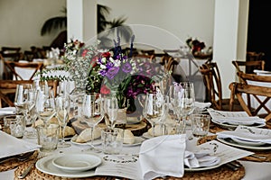 Beautiful table setup for a wedding reception with colorful flower arrangement centerpiece