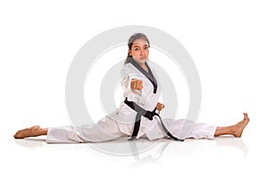 One punch tae kwon do girl doing split, full length portrait isolated photo