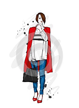 Beautiful, tall and slender girl in a stylish coat, trousers, and glasses. Stylish woman in high-heeled shoes. Fashion & Style.