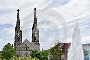 Beautiful and tall towers on evangelical church in Europe against the sky, Baden-Baden, Augustaplatz, Germany photo
