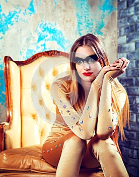 Beautiful tall young blond woman with sparkling golden makeup