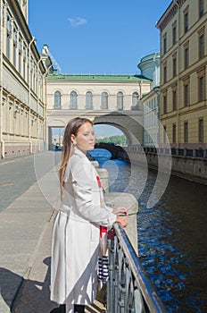 Sunny day, beautiful girl on the waterfront