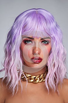 Beautiful tanned woman with lilac hair and bright fancy makeup