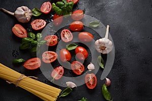 Beautiful tasty colorful pattern of Italian pasta, tomatoes and Fresh Basil. Gallic and olive oil. Food concept.