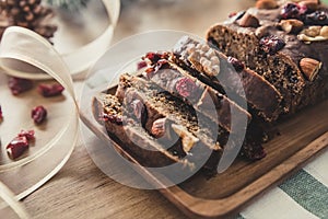 Beautiful tasty dried mixed nut Christmas fruit cake on wooden t