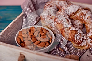 A beautiful and tasty Kringle covered with almonds with cup of almonds, breakfast concept