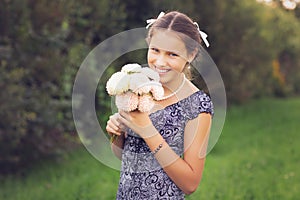 Beautiful teen age girl holding flowers