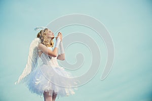 A beautiful teen with blonde curly hair as cupid - Valentines Day. Valentines day. Little angel in love. Girl angel with