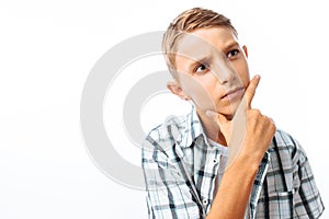 Beautiful teen boy posing, close up portrait, holding hand in front of face, in Studio on white background