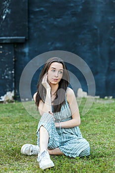 A beautiful teen brunette girl with a serious look and looking away