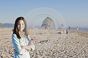 Beautiful teen girl on beach near Haystack Rock