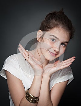 Beautiful teen girl with brown straight hair, posing on background