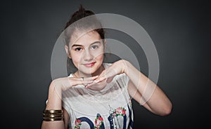 Beautiful teen girl with brown straight hair, posing on background