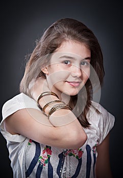 Beautiful teen girl with brown straight hair, posing on background