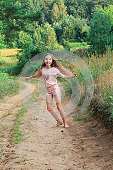 Beautiful teen girl  Is dancing outside at  summer sunset