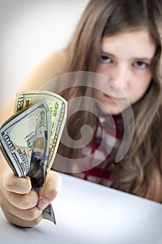 Beautiful teen girl grabs US dollars