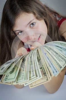 Beautiful teen girl holding US dollars