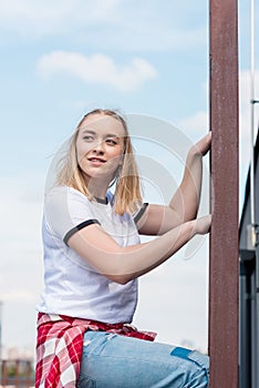 beautiful teen girl on ladder in front of