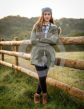 Beautiful Teen Girl Leaning Against A Farm Fence