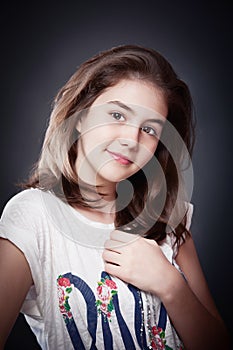 Beautiful teen girl with long straight hair, posing on background