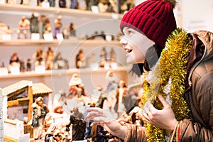 Beautiful teen girl with miniature Christmas figures