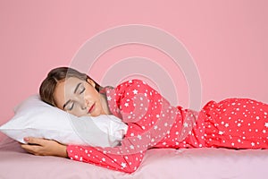 Beautiful teen girl sleeping with comfortable pillow on bed