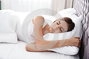 Beautiful teen girl sleeping with comfortable pillow in bed