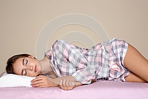 Beautiful teen girl sleeping with orthopedic pillow on bed