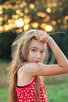 Beautiful Teen Girl is smiling and  enjoying nature in the park at Summer sunset