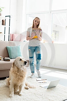 beautiful teen girl with stack of books studying at home with her