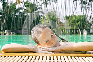 Beautiful teen irk relax at poolside in Thailand. Look in camera. Headshot. Beauty, vacation, healthy lifestyle