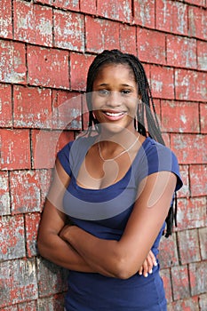 Beautiful teen next to weathered shingles