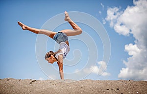 Beautiful teenage girl dancing and jumping on the beach