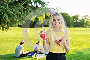 Beautiful teenage girl in a festiv hat on her birthday with a cake and candles.