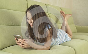 Beautiful teenage girl having fun communicating on smartphone