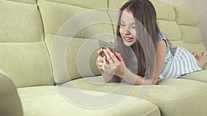 Beautiful teenage girl having fun communicating on smartphone