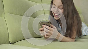 Beautiful teenage girl having fun communicating on smartphone stock footage video