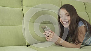 Beautiful teenage girl having fun communicating on smartphone stock footage video