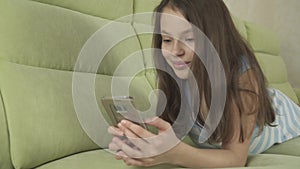 Beautiful teenage girl having fun communicating on smartphone stock footage video