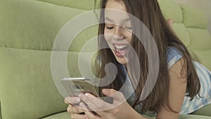 Beautiful teenage girl having fun communicating on smartphone stock footage video